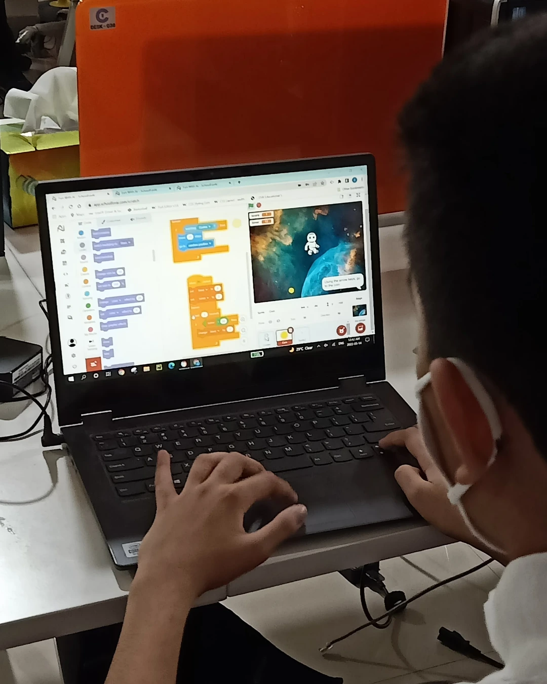 Student coding on laptop