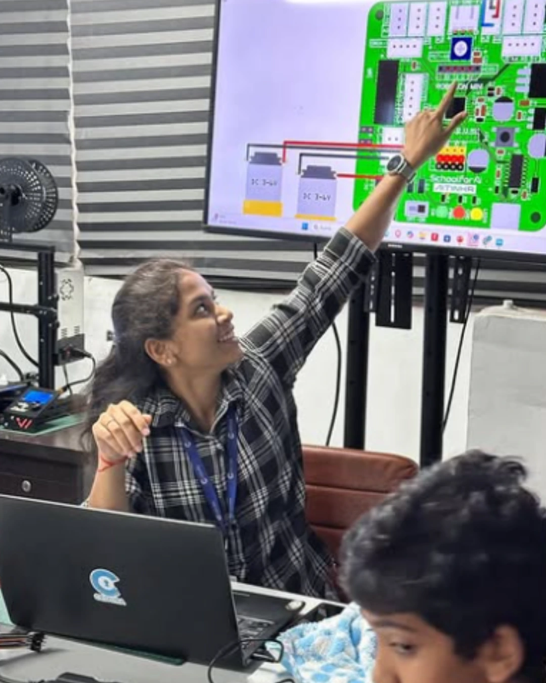 Student examining robotic hand